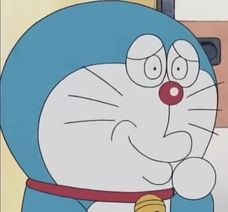 Doraemon đưa tay lên miệng cười nham hiểm